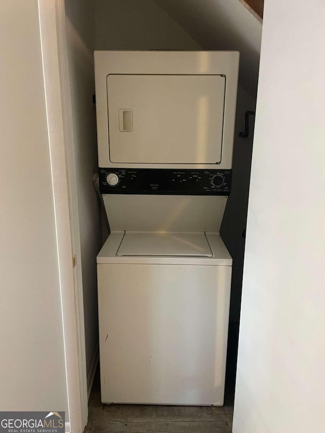 laundry area with stacked washing maching and dryer