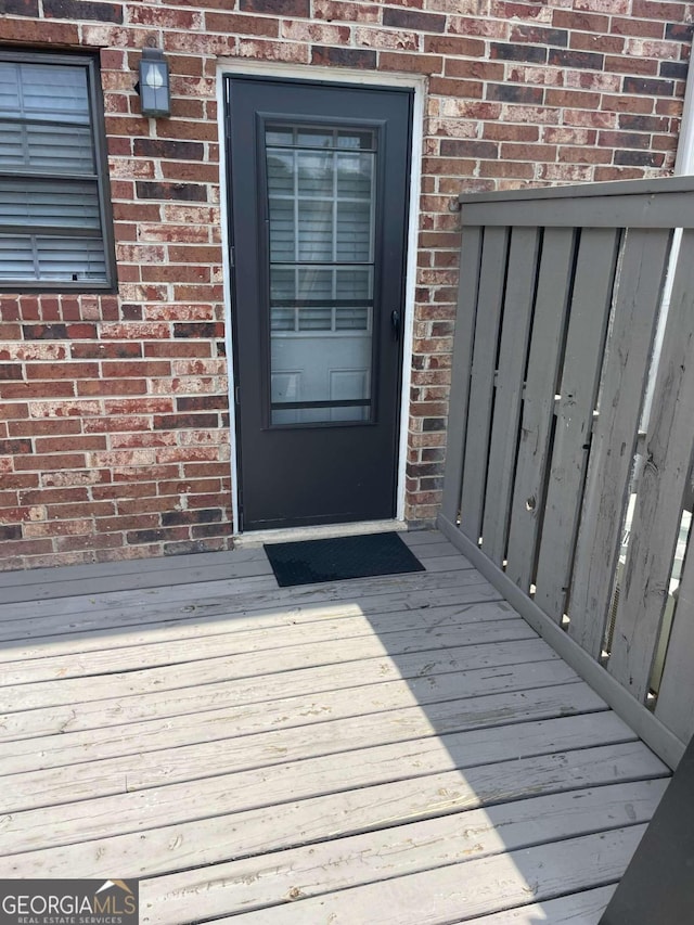 entrance to property featuring a deck