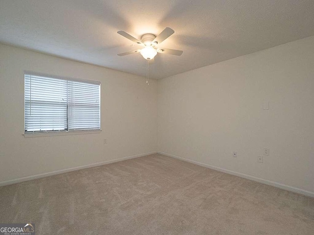 unfurnished room with ceiling fan and light colored carpet