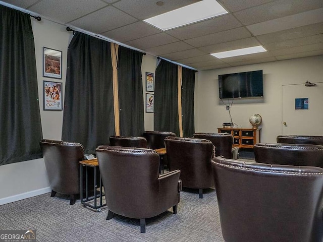 home theater room featuring carpet flooring and a drop ceiling