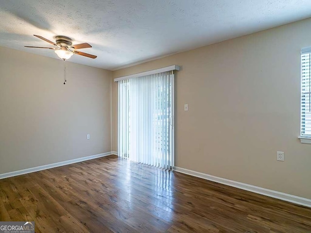 spare room with ceiling fan, dark hardwood / wood-style flooring, and a textured ceiling