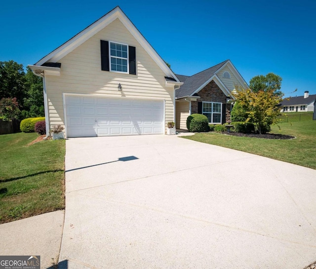 view of front of house with a garage and a front lawn