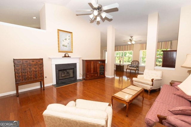 living room featuring wood-type flooring and ceiling fan