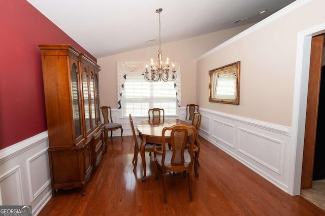 dining room featuring lofted ceiling, dark hardwood / wood-style floors, and a notable chandelier