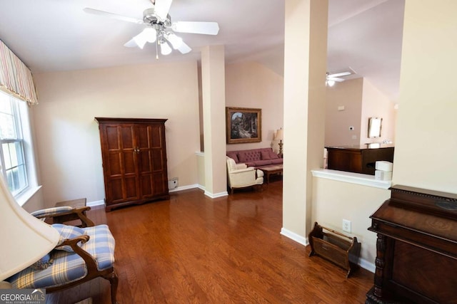 living area with lofted ceiling, dark wood-type flooring, and ceiling fan