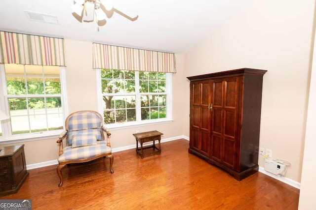 living area featuring wood-type flooring, vaulted ceiling, and ceiling fan