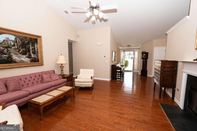 living room featuring ceiling fan and dark hardwood / wood-style flooring