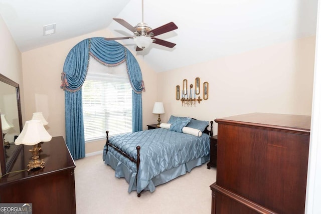 carpeted bedroom featuring vaulted ceiling and ceiling fan