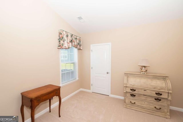 interior space with vaulted ceiling and light carpet