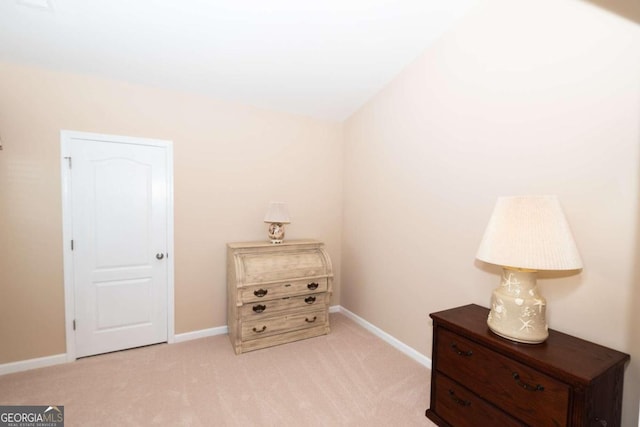 sitting room featuring light carpet