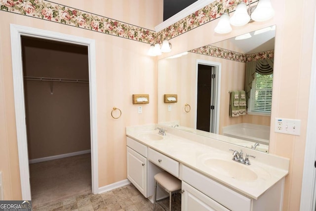 bathroom with vanity and a tub