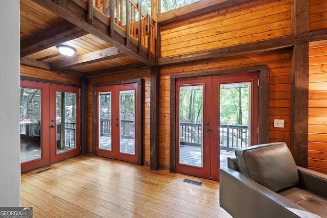 doorway with wood ceiling, light hardwood / wood-style flooring, beamed ceiling, and french doors