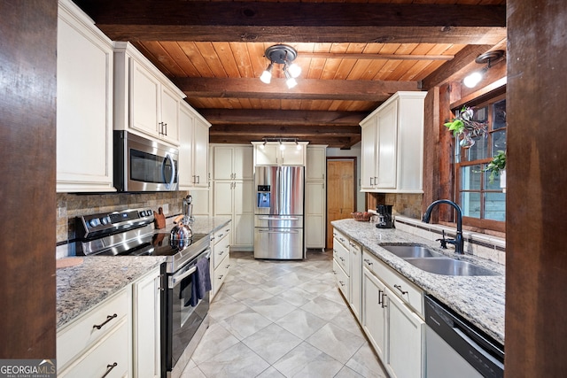 kitchen with tasteful backsplash, beamed ceiling, appliances with stainless steel finishes, and wood ceiling