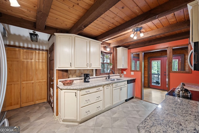 kitchen with sink, wooden ceiling, light tile patterned floors, and beamed ceiling