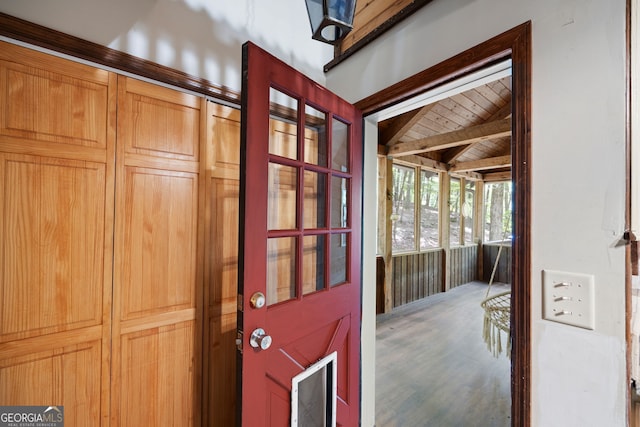 interior space with beamed ceiling and hardwood / wood-style flooring