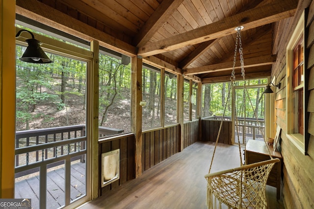 sunroom with wood ceiling and vaulted ceiling with beams