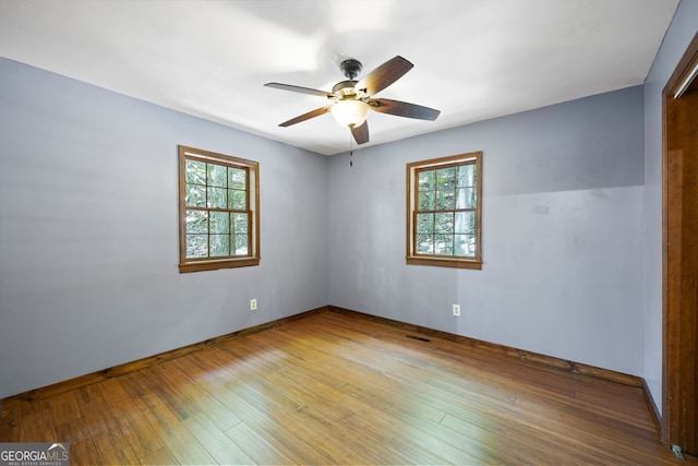 spare room with ceiling fan and wood-type flooring