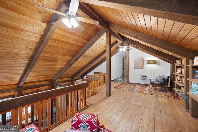 additional living space with wood ceiling, ceiling fan, vaulted ceiling with beams, and light hardwood / wood-style floors