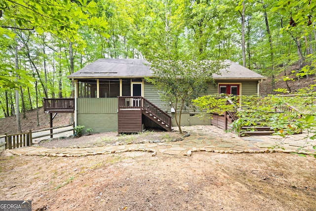 view of front facade with a sunroom and a deck