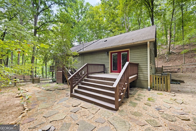 rear view of property featuring a wooden deck