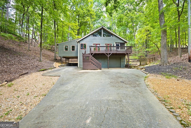 view of front of property with a wooden deck and a garage