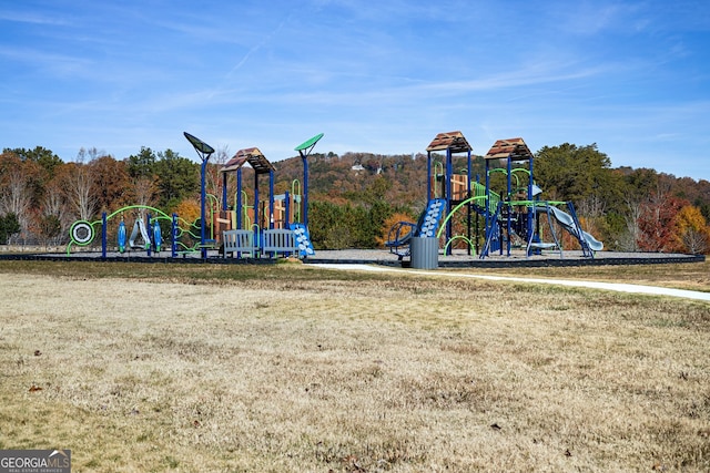 view of jungle gym featuring a lawn