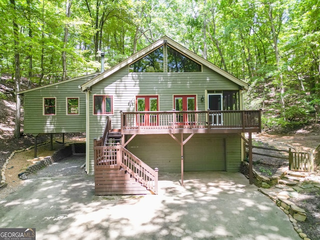 rear view of property with a garage