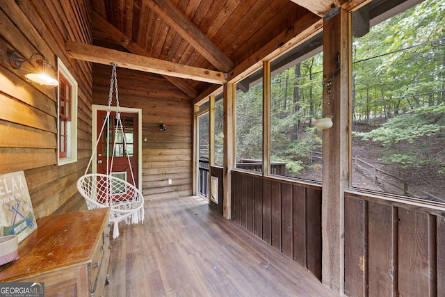 unfurnished sunroom with wood ceiling and lofted ceiling with beams