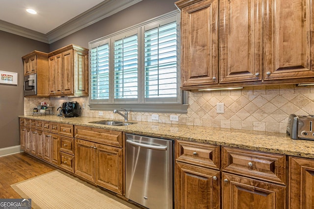 1829 Buckhead Valley Ln NE, Atlanta, GA 30324 - kitchen featuring ornamental molding, wood finished floors, appliances with stainless steel finishes, a sink, and brown cabinetry