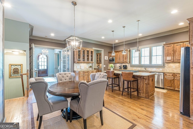 1829 Buckhead Valley Ln NE, Atlanta, GA 30324 - dining space featuring ornamental molding, light wood-style flooring, and a chandelier