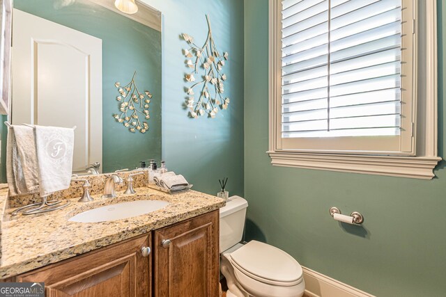 bathroom featuring vanity and toilet