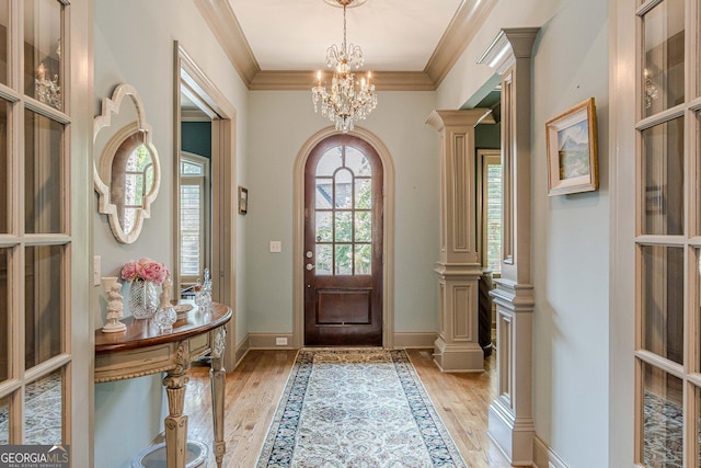 1829 Buckhead Valley Ln NE, Atlanta, GA 30324 - foyer entrance featuring a notable chandelier, crown molding, baseboards, and light wood-type flooring