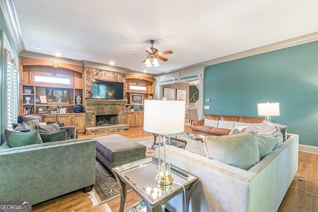 1829 Buckhead Valley Ln NE, Atlanta, GA 30324 - living room featuring crown molding, wood finished floors, a stone fireplace, baseboards, and ceiling fan