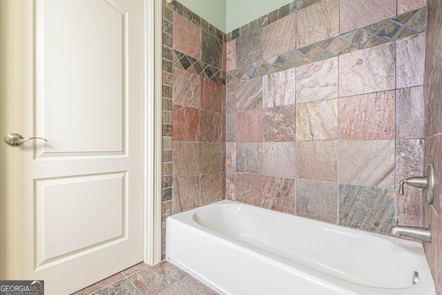 bathroom featuring tiled shower / bath combo and tile patterned floors