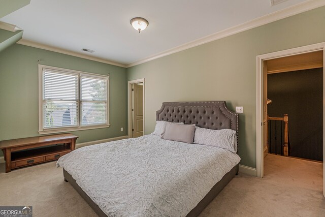 carpeted bedroom with ornamental molding