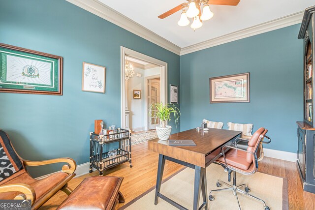 home office with ceiling fan with notable chandelier, hardwood / wood-style flooring, and ornamental molding