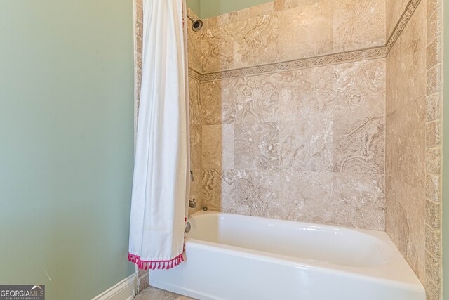 bathroom featuring shower / bathtub combination with curtain