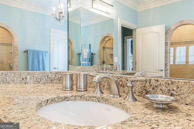 bathroom featuring crown molding, vanity, a chandelier, and walk in shower