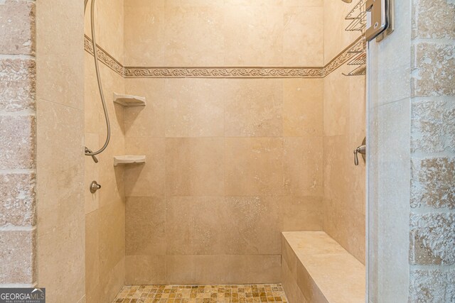 bathroom with tiled shower