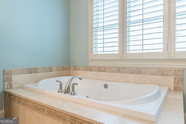 bathroom with a relaxing tiled tub