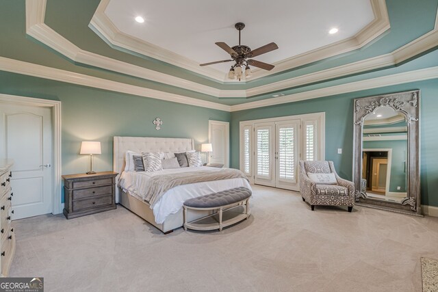 carpeted bedroom with ornamental molding, a raised ceiling, access to outside, and ceiling fan