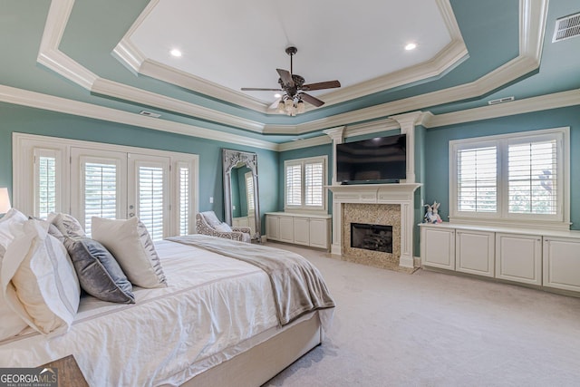 1829 Buckhead Valley Ln NE, Atlanta, GA 30324 - bedroom with visible vents, a premium fireplace, access to outside, light carpet, and a tray ceiling