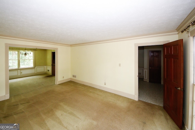 unfurnished room with light carpet, baseboards, visible vents, and crown molding