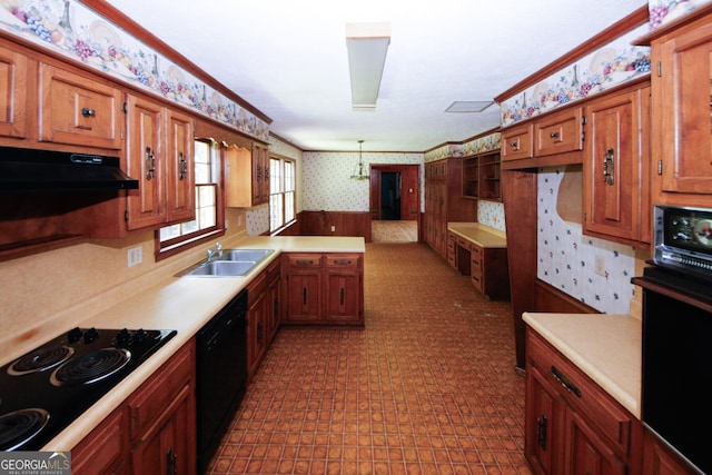 kitchen with wallpapered walls, wainscoting, ornamental molding, light countertops, and black appliances