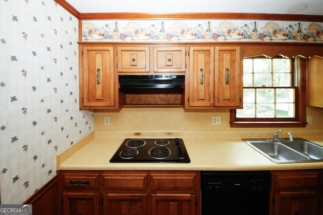 kitchen featuring black appliances, wallpapered walls, light countertops, and exhaust hood