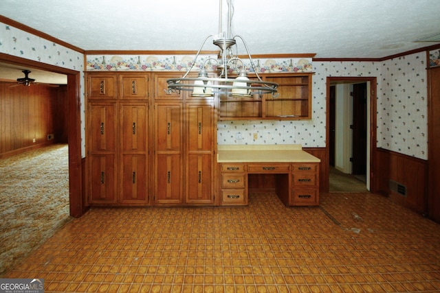 kitchen with open shelves, light countertops, decorative light fixtures, and wallpapered walls