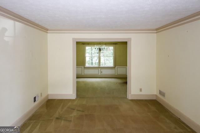 unfurnished room with baseboards, visible vents, crown molding, a textured ceiling, and carpet flooring