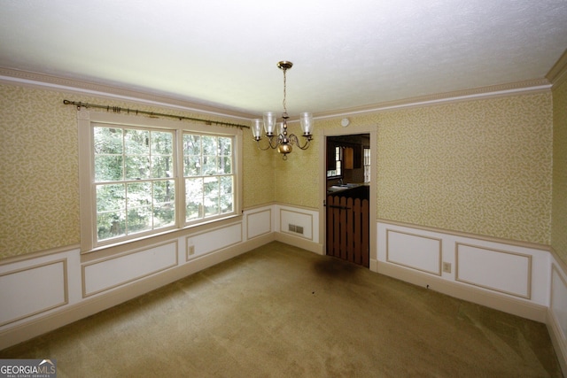 unfurnished dining area with a wainscoted wall, crown molding, light colored carpet, a chandelier, and wallpapered walls