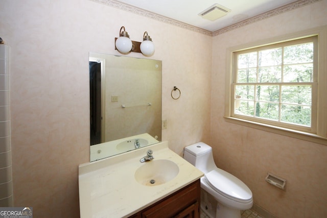 bathroom featuring toilet, visible vents, and vanity