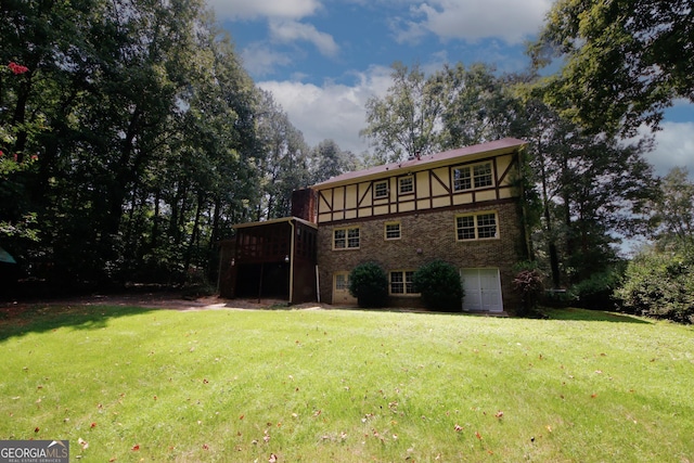 rear view of house with stone siding, a yard, a deck, and stucco siding